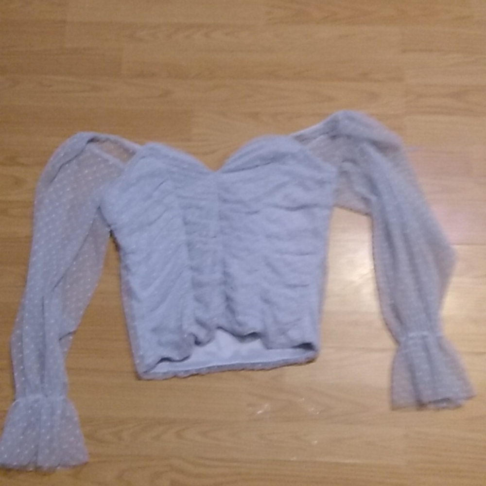 Light blue women's shirt. Poofy sleeve/sheer.
